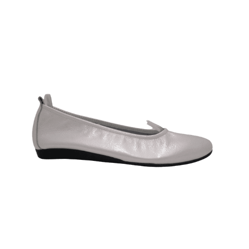 A single white patent leather ballet flat with a latex sole, displayed against a plain background.
